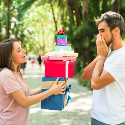 woman-giving-stack-gifts-her-surprised